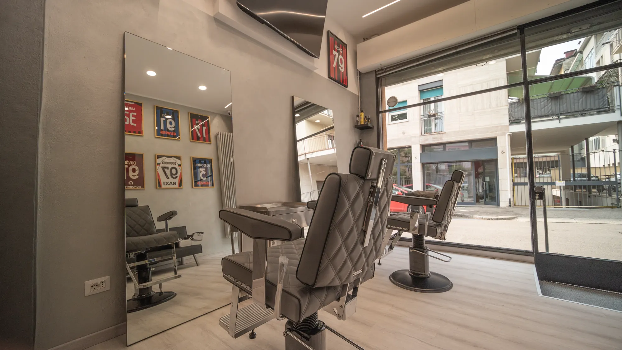 Inside the shop: two stations, mirrors and a window onto the street
