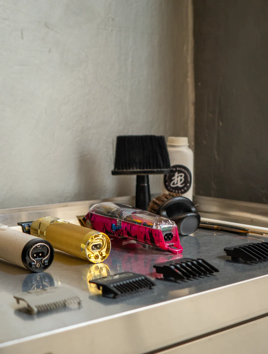 Clippers, scissors and combs laid out in order on the work bench