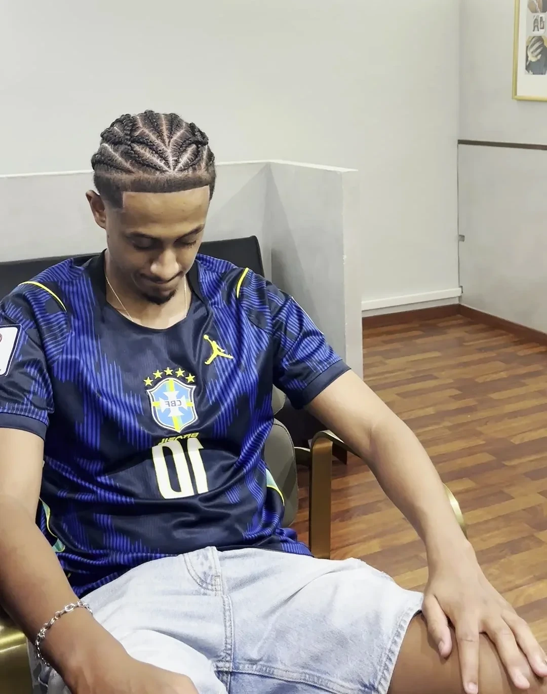 Cornrows just finished, the client seated in the shop