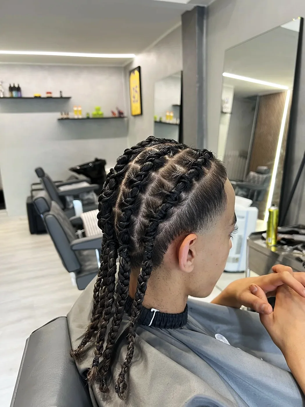 Cornrows running down the side above a fade