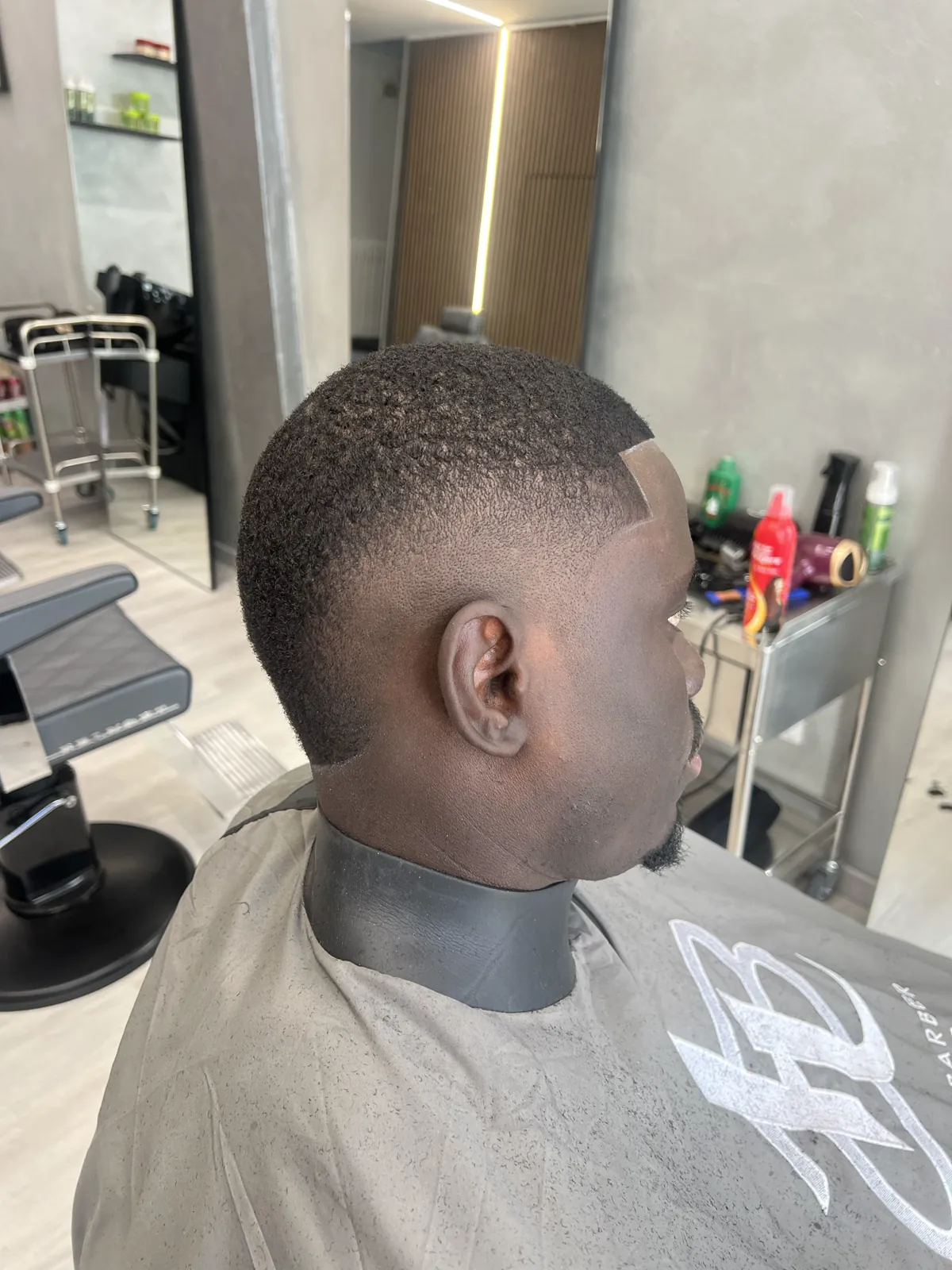 A skin fade taken down to the skin, seen in profile