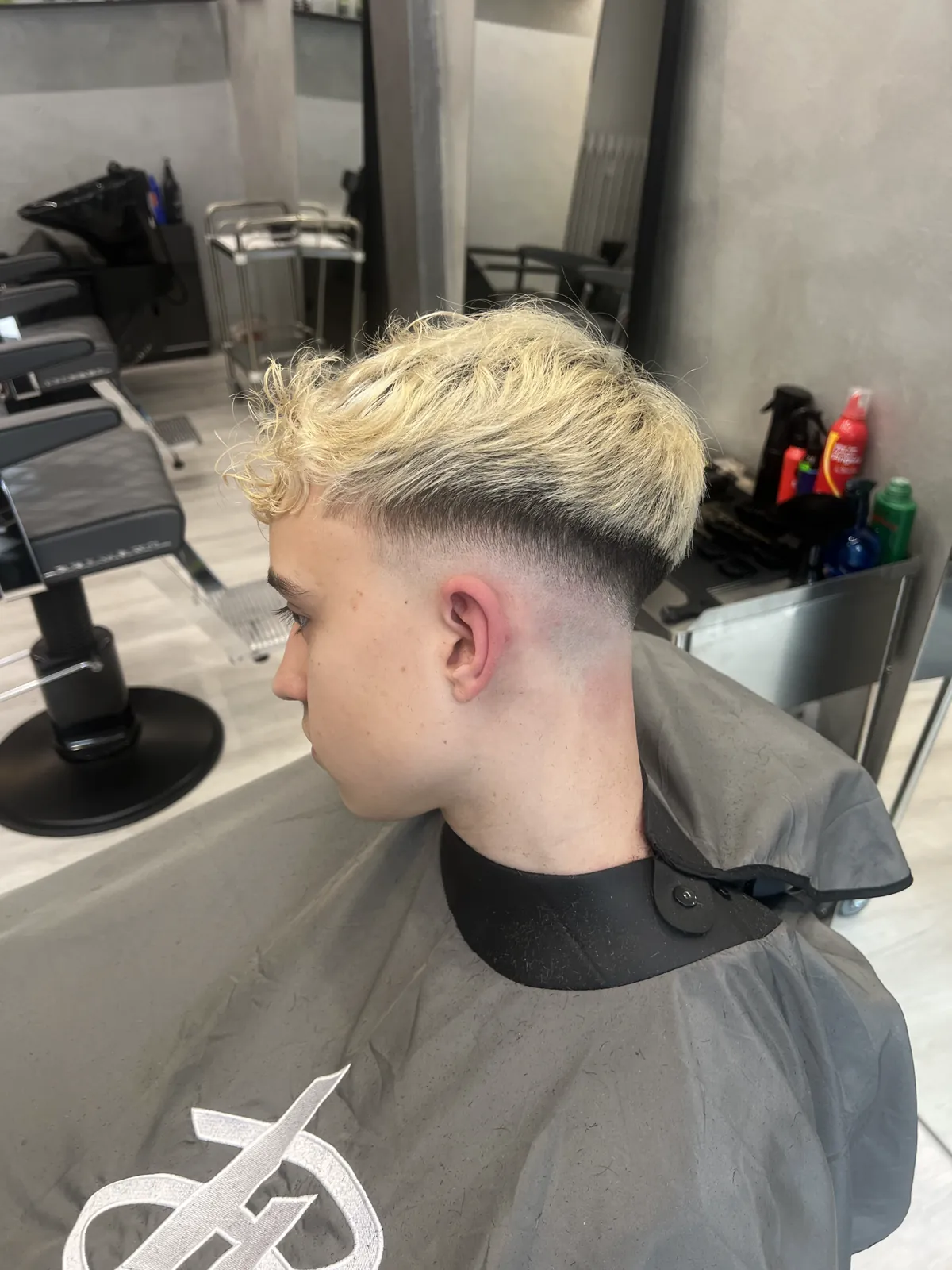 Platinum blonde bleached hair with a side fade