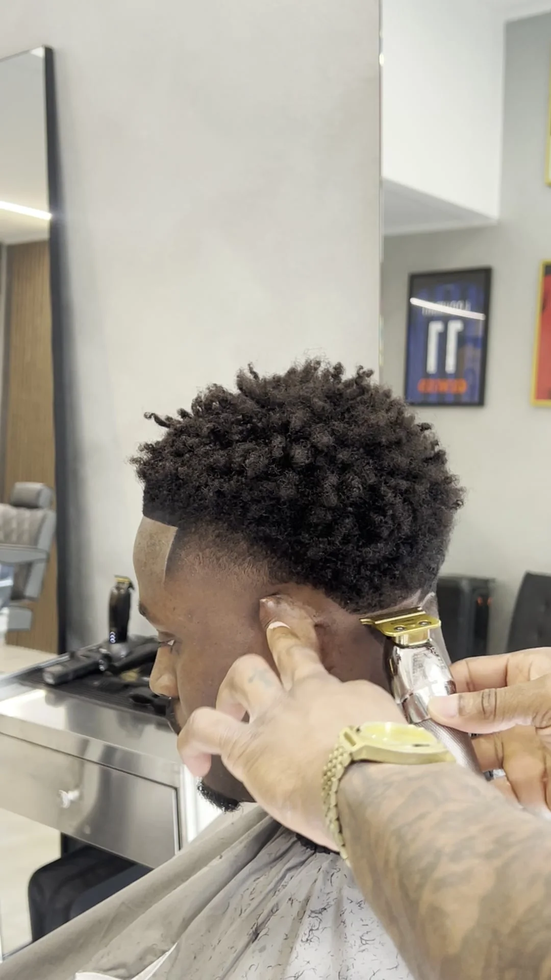 Fading an afro cut with the clipper, in the shop
