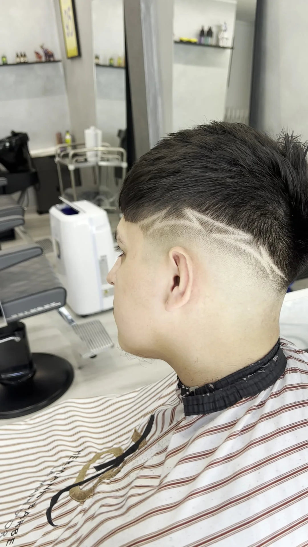 A fade with a razored part line on the side